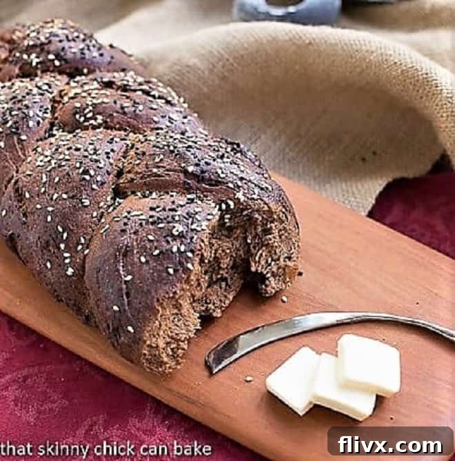 Rustic Pumpernickel Loaf on a wooden cutting board, showcasing its dark crust and inviting texture