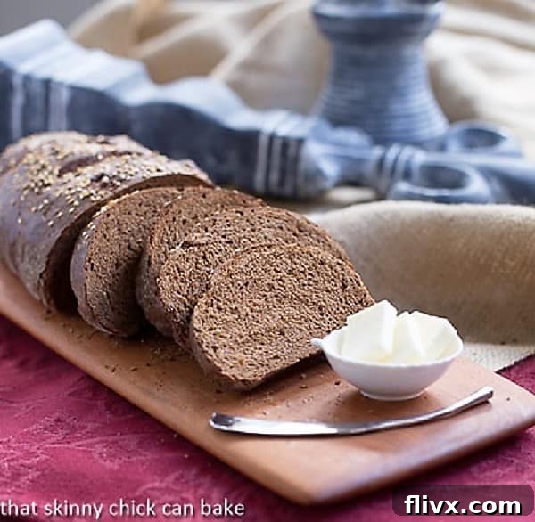 Perfectly sliced Pumpernickel Loaves on a rustic cutting board, highlighting the dense, dark interior