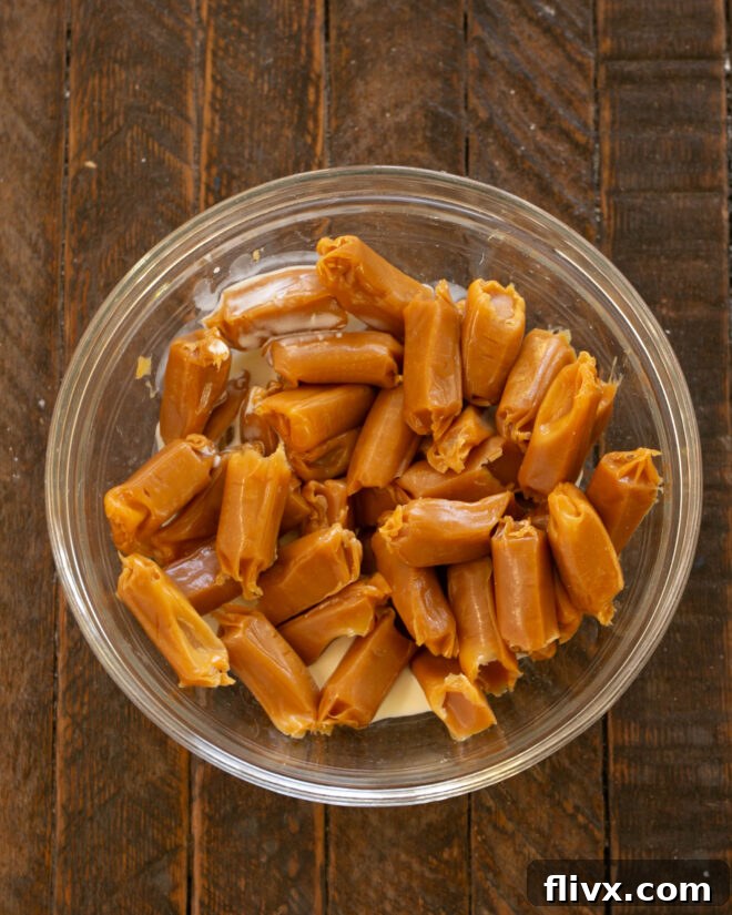 Unwrapped caramels and heavy cream placed in a microwave-safe bowl, ready to be melted.