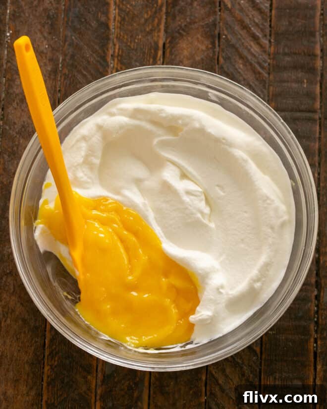 Adding custard to whipped cream.