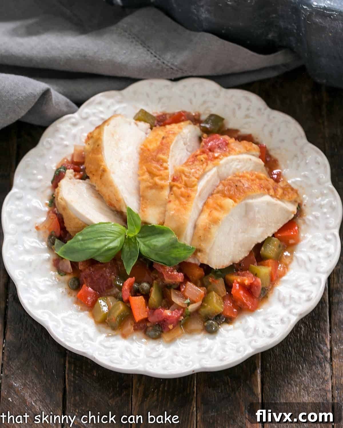 An inviting overhead view of Chicken Cacciatore elegantly fanned out on a decorative white plate, showcasing the rich sauce and tender chicken, ready to be enjoyed.