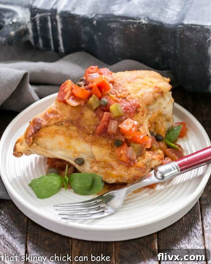 Chicken Cacciatore on a white plate with a red handle fork.