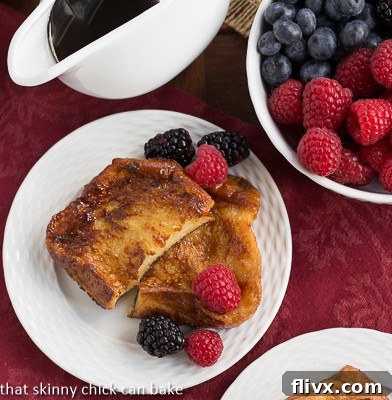 Sugar-Crusted French Toast - a double coating of sugar make this rich, eggy French toast dessert worthy! Overhead view of Sugar-Crusted French Toast on a white ceramic plate with fresh berries.