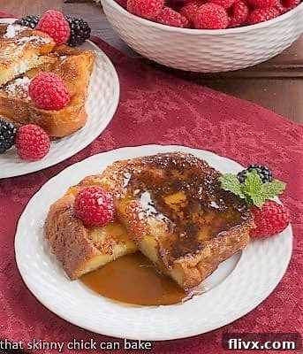 Caramelized French Toast 2 Sugar crusted slice of Frenc Toast cut in half on a plate with syrup and berries