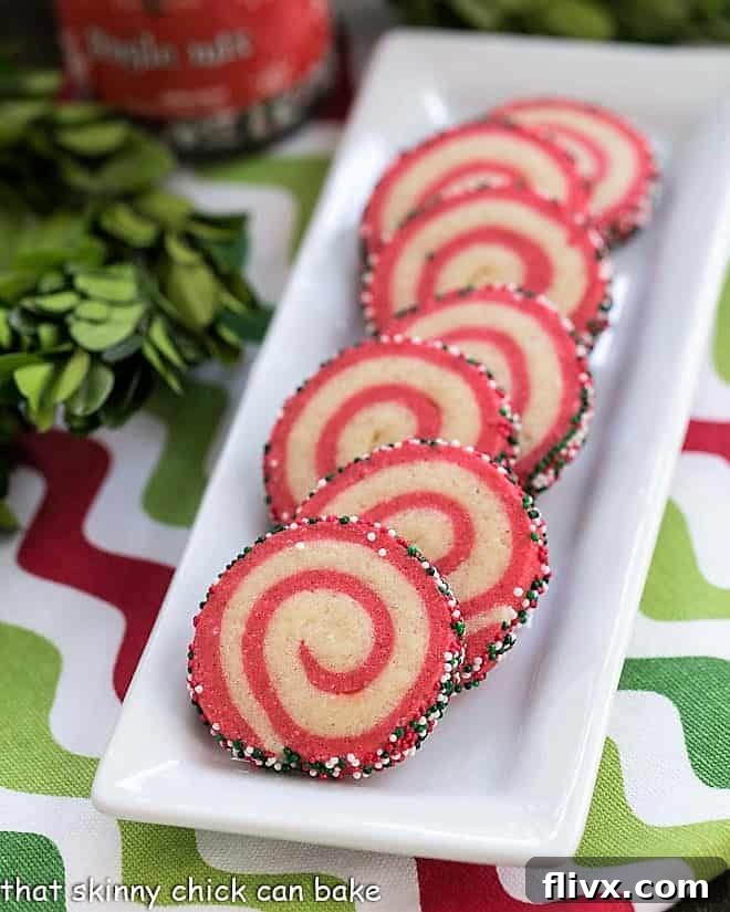 Holiday Pinwheel Cookies on a narrow white ceramic tray, ready to be served at a festive gathering.