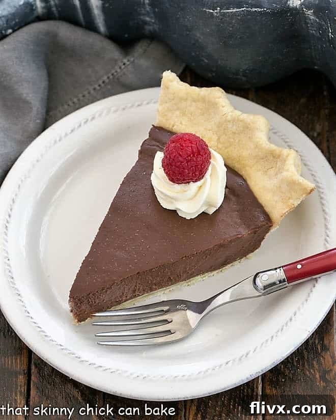 Slice of pudding pie on a white dessert plate.
