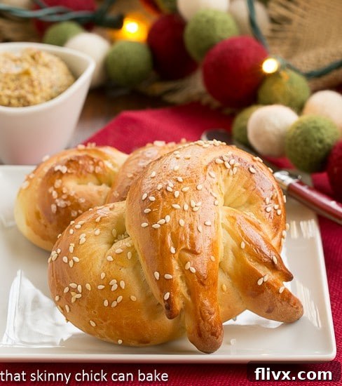 A single Homemade Challah Pretzel, golden brown and perfectly shaped, resting on a small white plate, ready to be enjoyed.