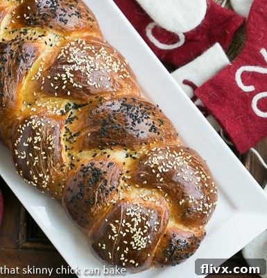 Perfect Braided Challah from Baking with Julia on a white ceramic tray, showcasing its golden crust and beautiful braid.