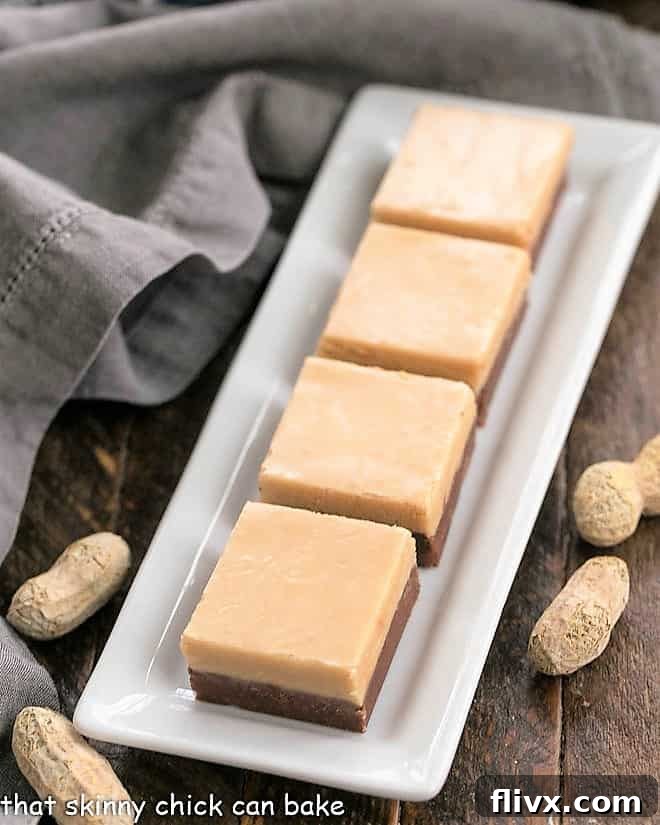 Beautifully Layered Chocolate Peanut Butter Fudge - A stunning and delicious addition to any dessert table. Close-up of perfectly layered chocolate peanut butter fudge squares, neatly arranged on a white serving tray, ready for any gathering.