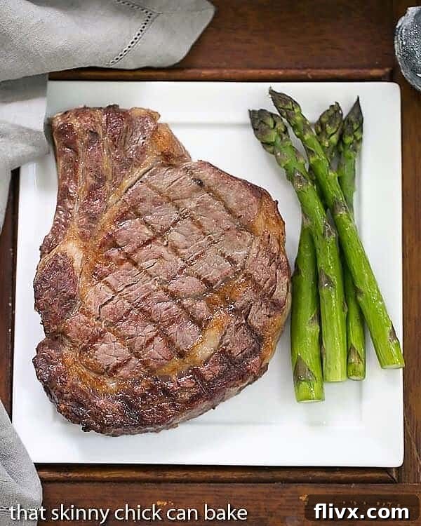 Rib Eye Steak on a dinner plate with asparagus.