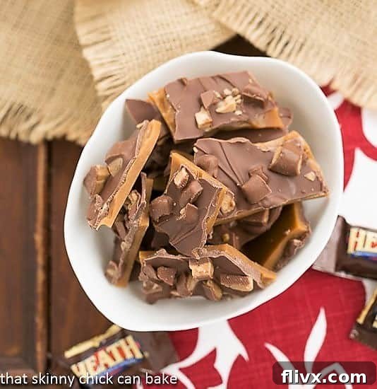 A generous bowl filled with freshly made Double Dose English Toffee, showcasing the delightful Heath bar topping.