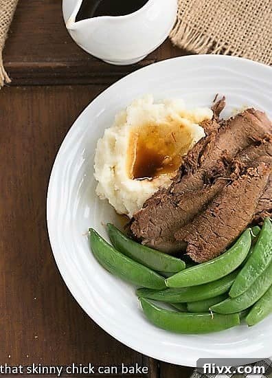 Plated Coffee Glazed Brisket with sugar snap peas and mashed potatoes, viewed from above.