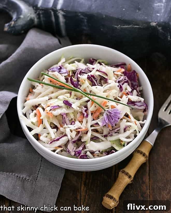 KFC Coleslaw Recipe with Buttermilk Dressing - Perfect slaw for picnics and gatherings KFC Coleslaw Recipe with Buttermilk Dressing in a white serving bowl, garnished for presentation.