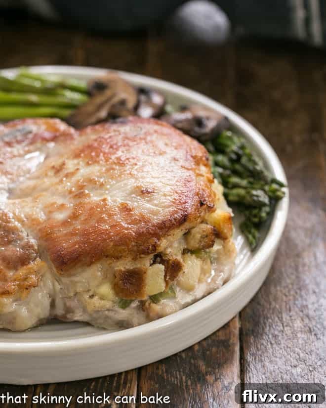 Close view of Stuffed Pork Chops with Apple Thyme Sauce showcasing the delicious filling.