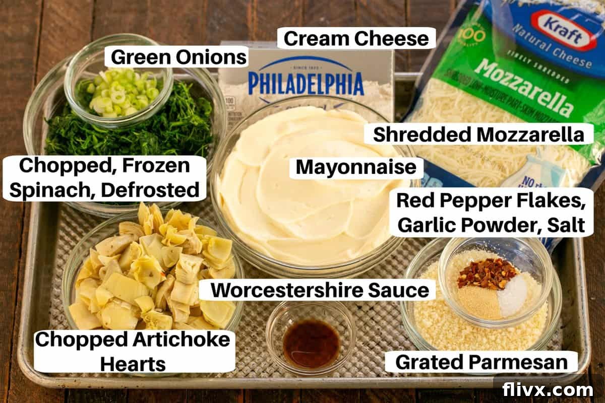 Spinach Artichoke Dip Ingredients laid out on a sheet pan with labels, showcasing fresh and pantry items.