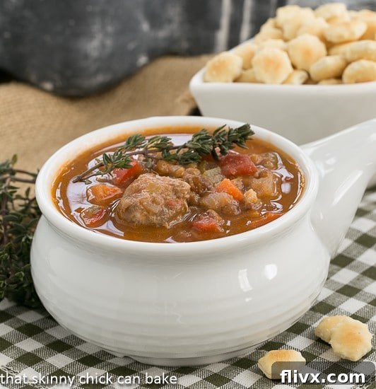 A bowl of Sausage, Lentil and Vegetable Chowder in a white soup bowl, showcasing the rich texture and ingredients.