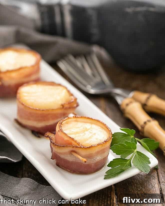 Bacon wrapped scallops on a white tray
