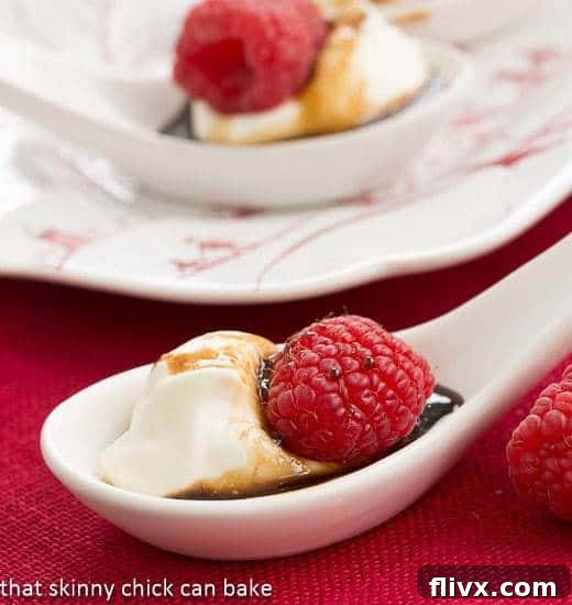 Balsamic Raspberries with Mascarpone Cream in white soup spoons, ready to serve