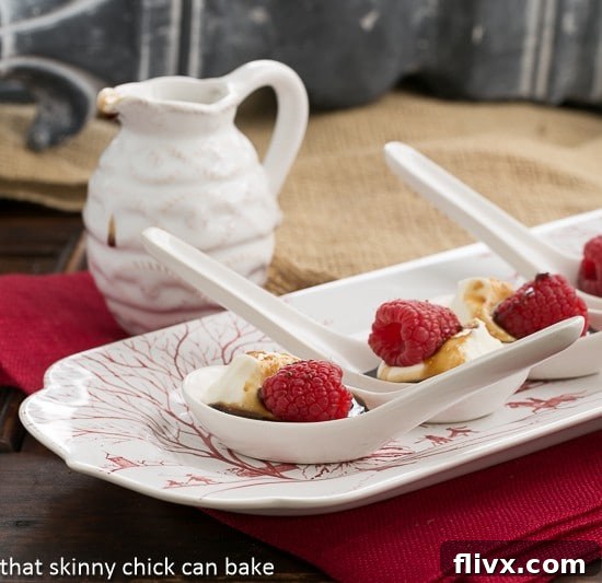 Balsamic Raspberries with Mascarpone Cream in Chinese Soup Spoons on a red and white tray, perfect for serving