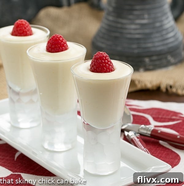 Dreamy White Chocolate Mousse spiked with Frangelico in decorative shot glasses topped with raspberries.