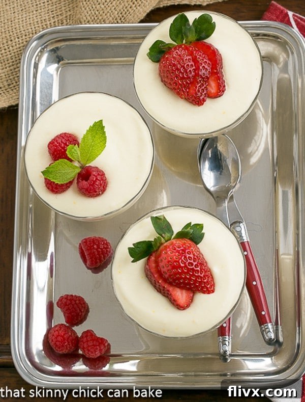 Dreamy White Chocolate Mousse Recipe spiked with Frangelico in glass parfait dishes on a silver tray.