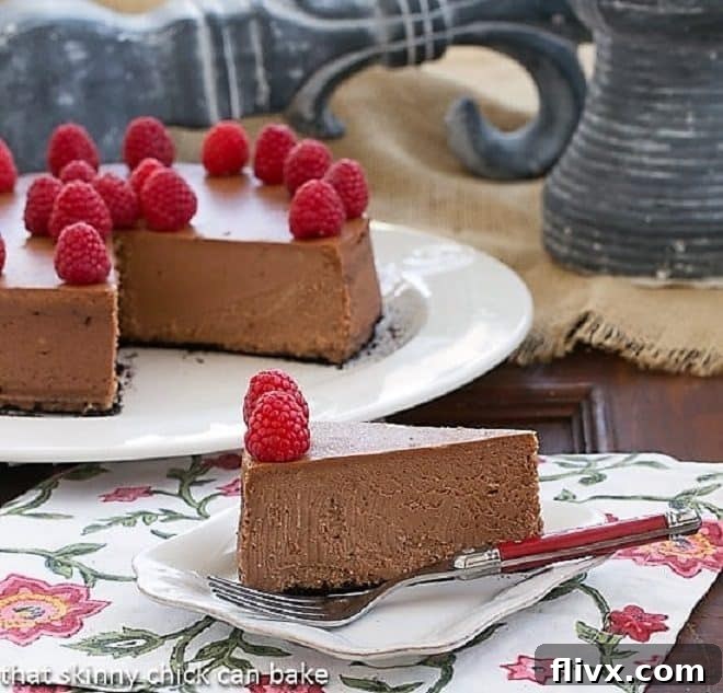 Chocolate-Mascarpone Cheesecake slice on a white cake plate with a fork, garnished beautifully.