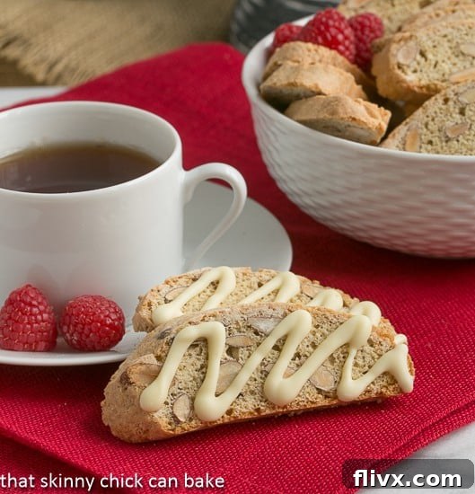 Close-up of golden brown Cantuccini next to a cup of hot tea, inviting a delightful dunk.
