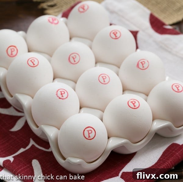 A carton of Safest Choice Eggs clearly displaying the red P in a circle logo, emphasizing their pasteurized status for safe consumption.