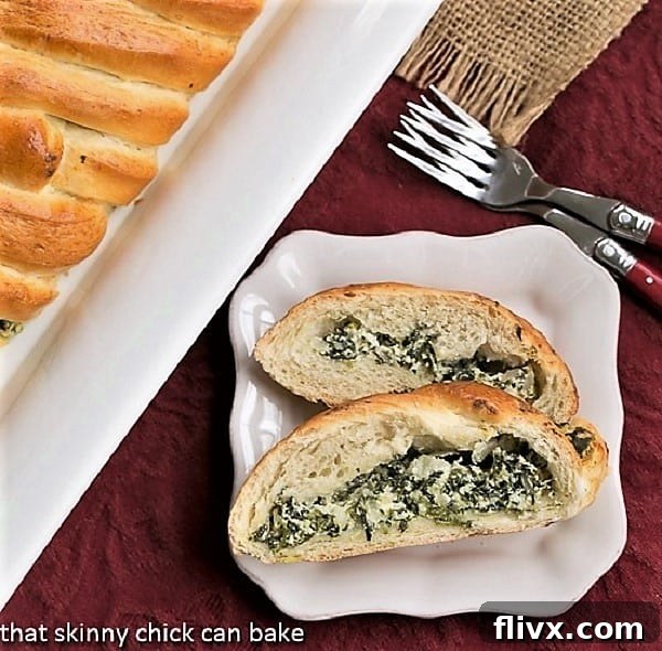 Slices of golden-brown Spinach and Onion Braid on a square white plate, with two red-handled forks poised for enjoyment.