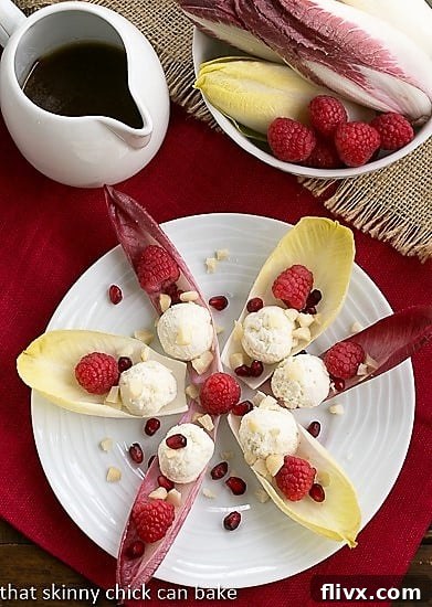 Overhead view of a star of Endive Cups with Blue Cheese, Raspberries and Macadamia Nuts, beautifully arranged.