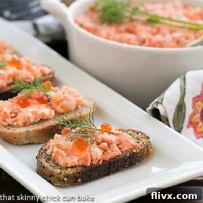 Salmon Rillettes on toasts on a white platter, garnished with fresh dill.