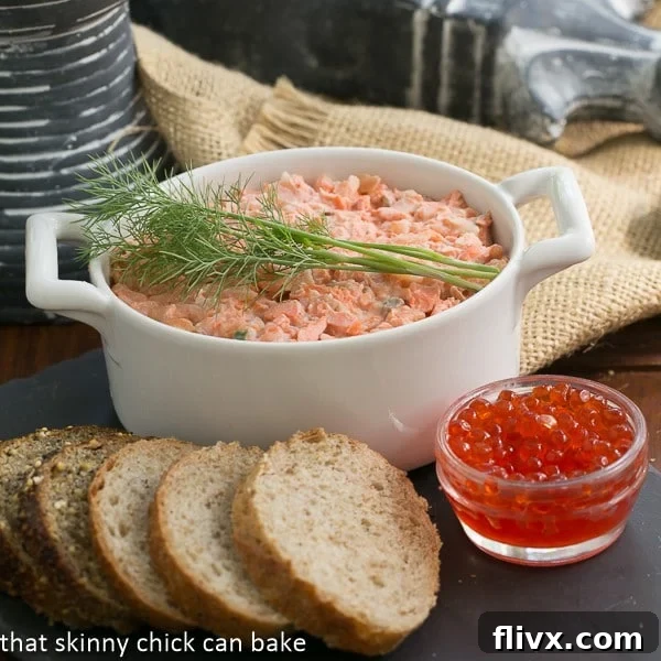Salmon Rillettes in a white terrine topped with dill.