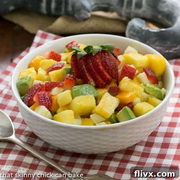 A vibrant bowl of Mango Strawberry Avocado Salad, a healthy and refreshing tropical delight.