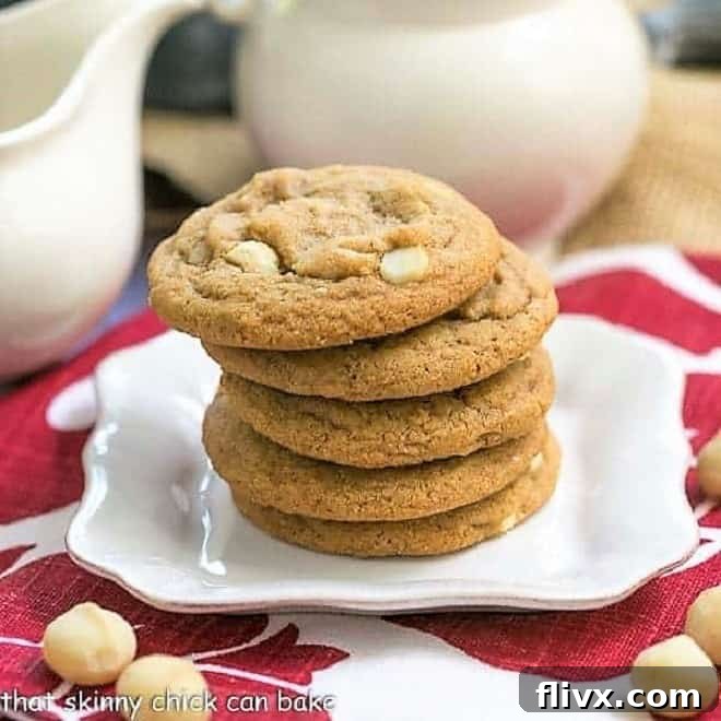 A perfectly arranged stack of three White Chocolate Macadamia Nut Cookies, highlighting their golden-brown edges and soft centers.
