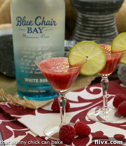 Frozen Fresh Berry Daiquiris in front of a bottle of rum, suggesting an easy homemade cocktail