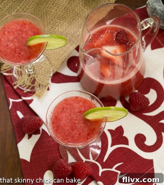 Overhead view of Frozen Fresh Berry Daiquiris in glasses and in a pitcher, ready to serve