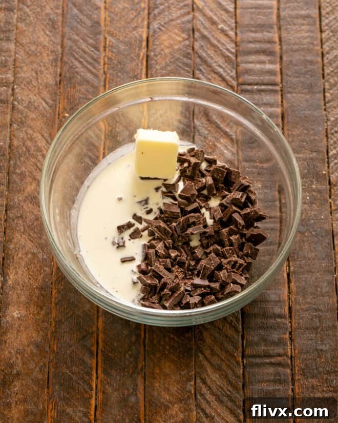 Ingredients for chocolate ganache – chocolate, butter, and cream – melting together to create a silky glaze.