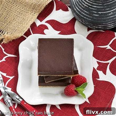 An overhead shot of a stack of Truffle Brownies on a white square plate, highlighting their luxurious layers and texture.