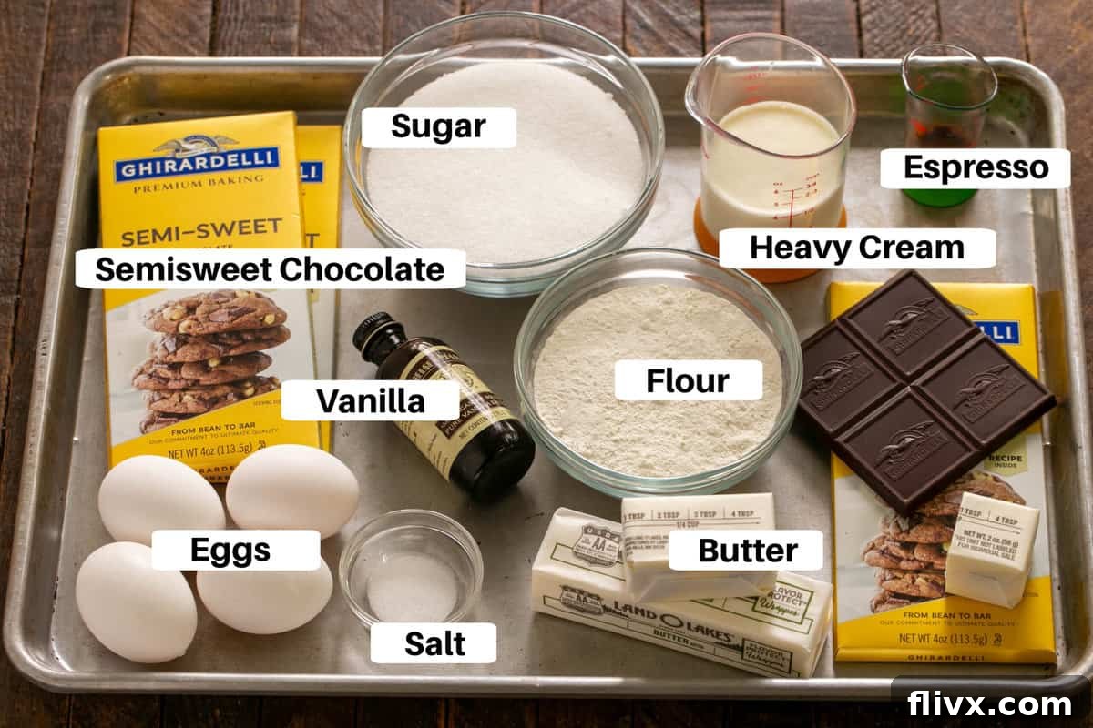 Ingredients for the rich truffle brownie filling, including chocolate, butter, and eggs, on a sheet pan.