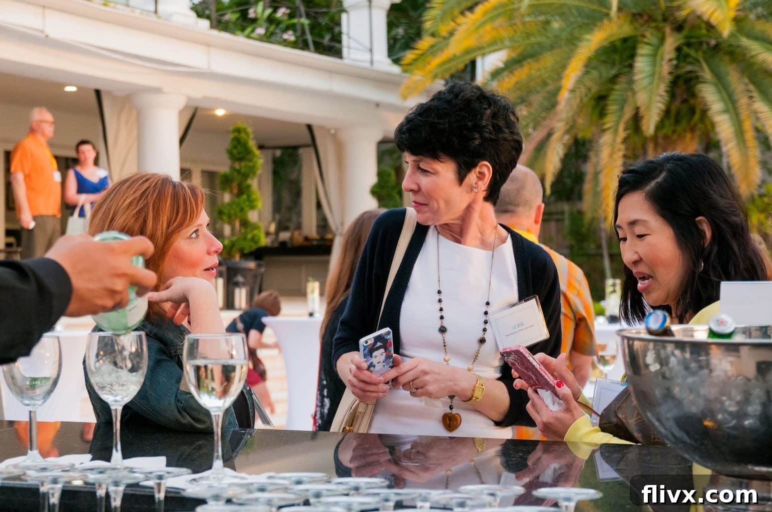A candid photo of three friends enjoying wine and cheese at a BlogHerFood event, embodying the spirit of community.
