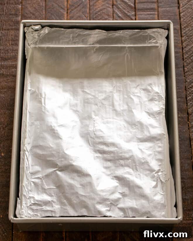 Baking pan meticulously lined with nonstick foil, ready for the shortbread crust.