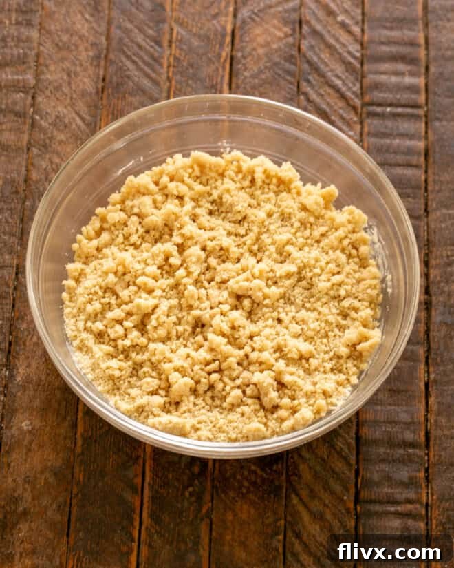 Shortbread crust ingredients, including brown sugar and butter, perfectly mixed in a bowl.