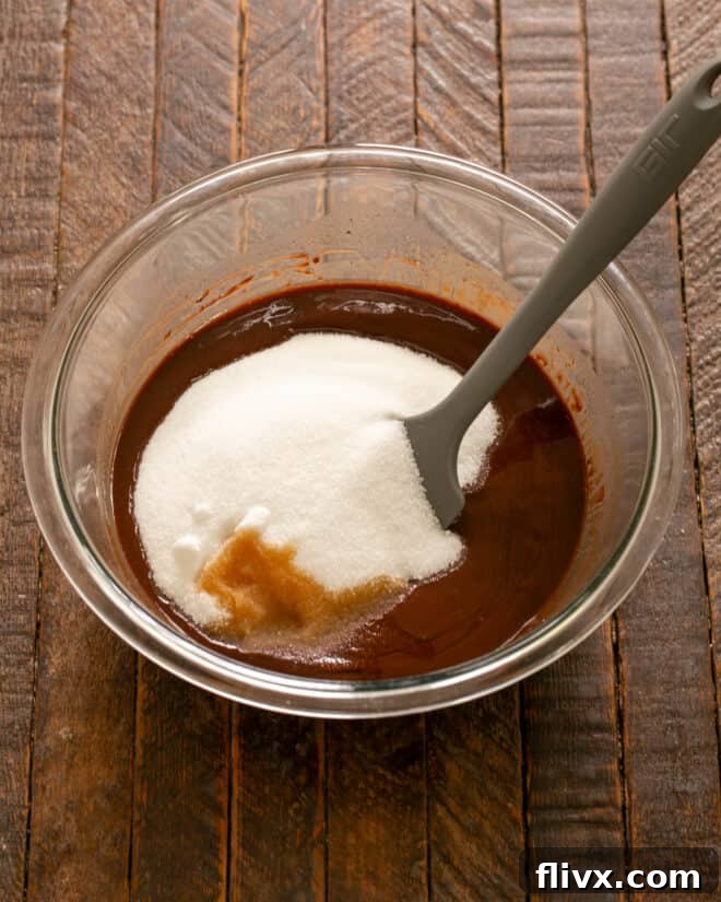 Granulated sugar, vanilla, and eggs being added to the melted chocolate mixture, step-by-step.