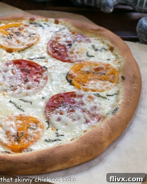 Pizza Margherita fresh out of the oven on a sheet of parchment, showing a perfectly golden crust and melted cheese.