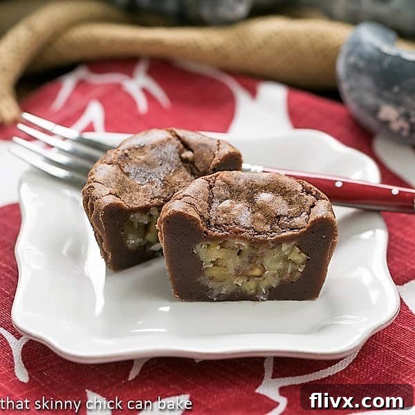German Chocolate Brownie Cupcakes cut in half on a white dessert plate with a red handled fork