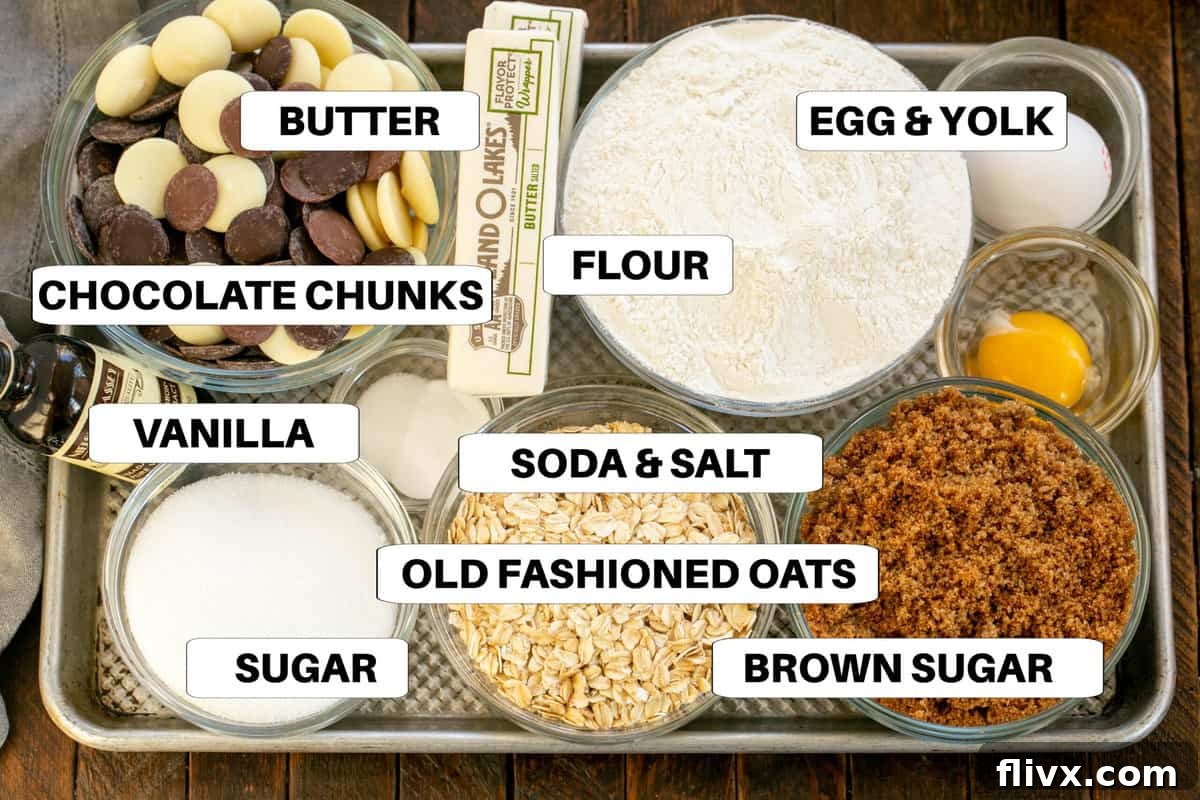 Oatmeal cookie ingredients displayed on a sheet pan with clear labels.