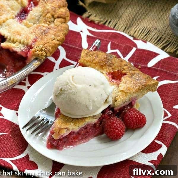 Lattice Topped Raspberry Pie slice with ice cream. A perfect summer dessert.