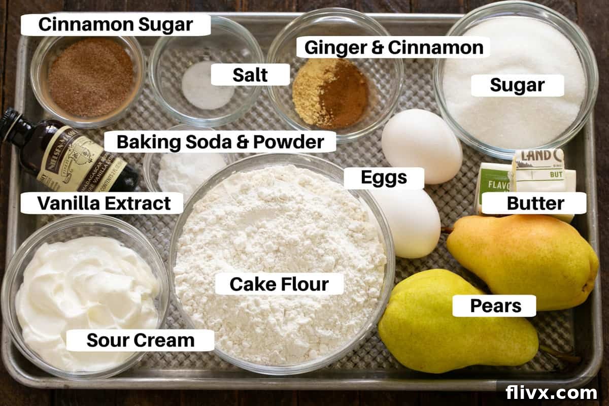 All ingredients for Sour Cream Pear Bread laid out on a sheet pan with labels.