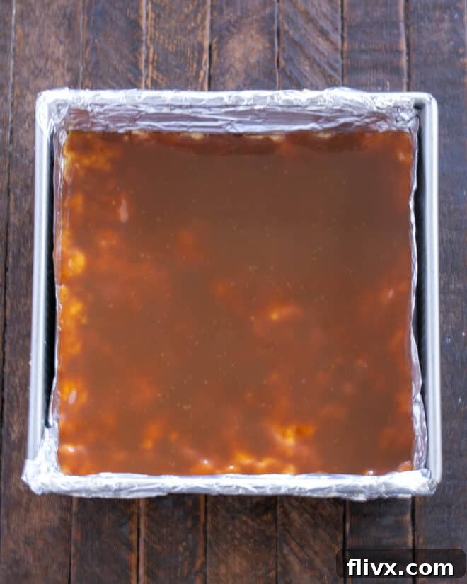 Step 6: Spread warm caramel over the crust.