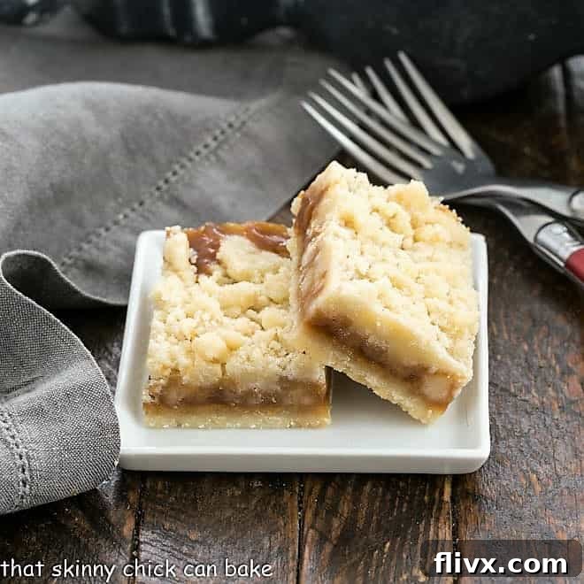 Two caramel bars on a small white plate.